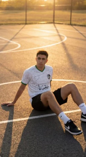 Couple wearing white and black Syria football jerseys - Arab Jerseys