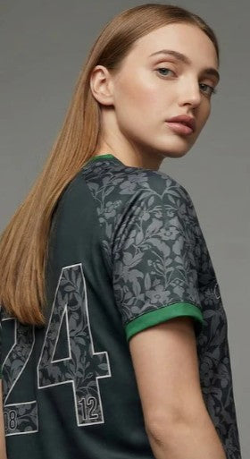 Woman wearing white Syrian football jersey with jeans - diaspora style